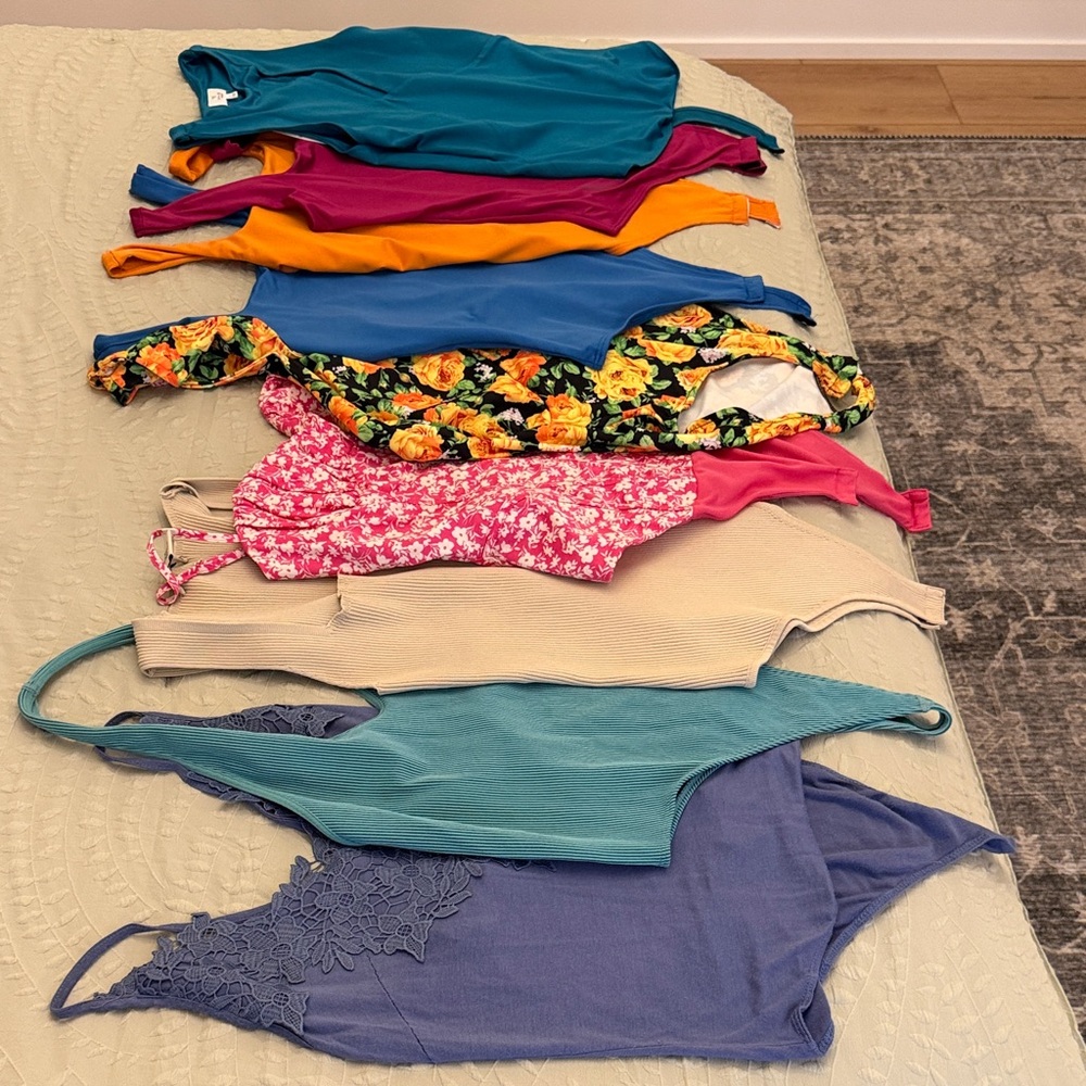 Women's set of 9 S/M bodysuits some with tags most never worn!
